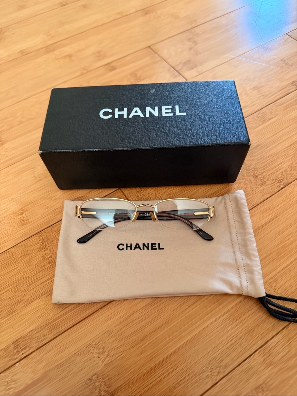 CHANEL Gold Rimless Eyeglasses with Black Temples